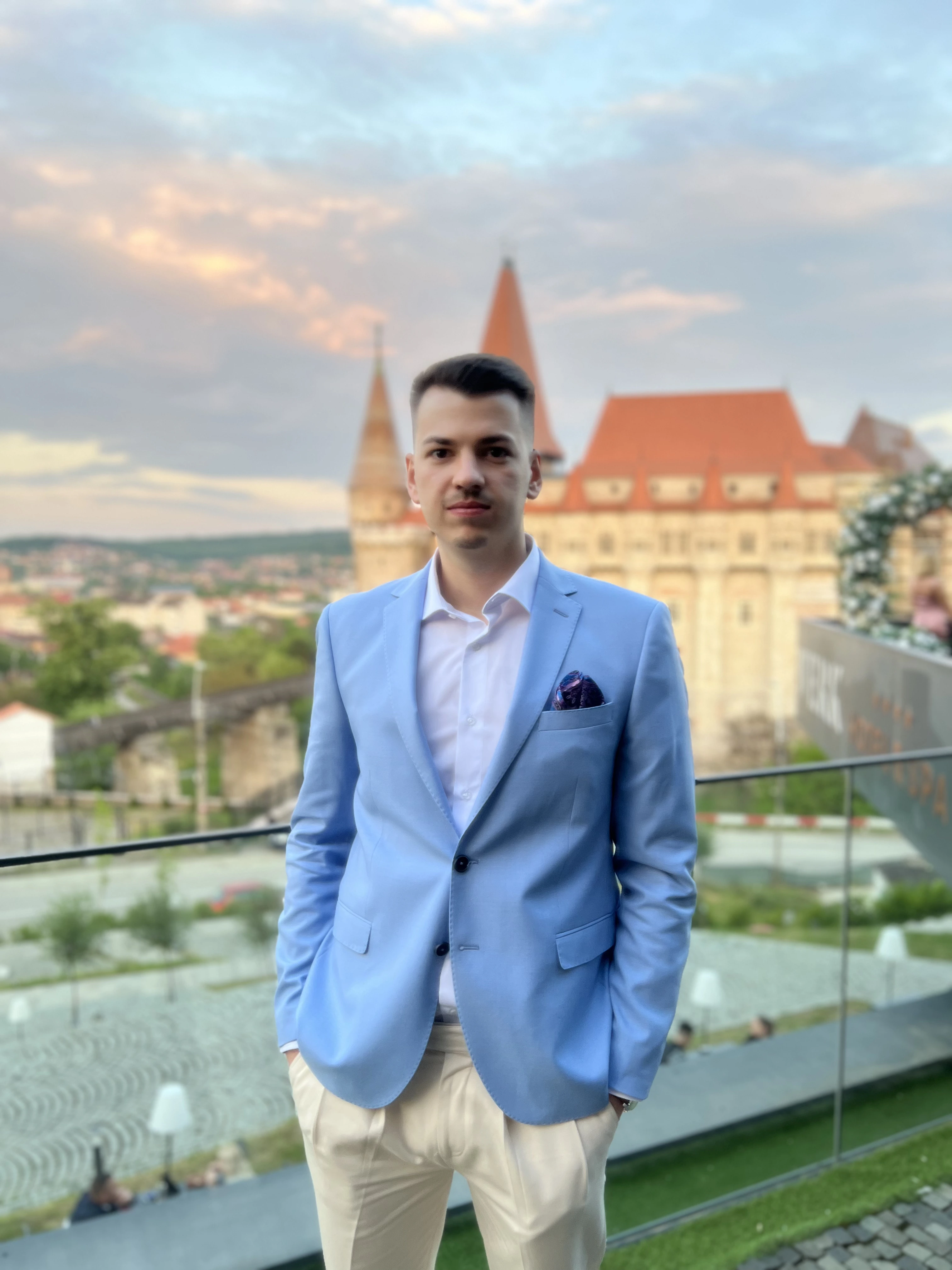A guy (me) posing nearby Corvin Castle in Romania